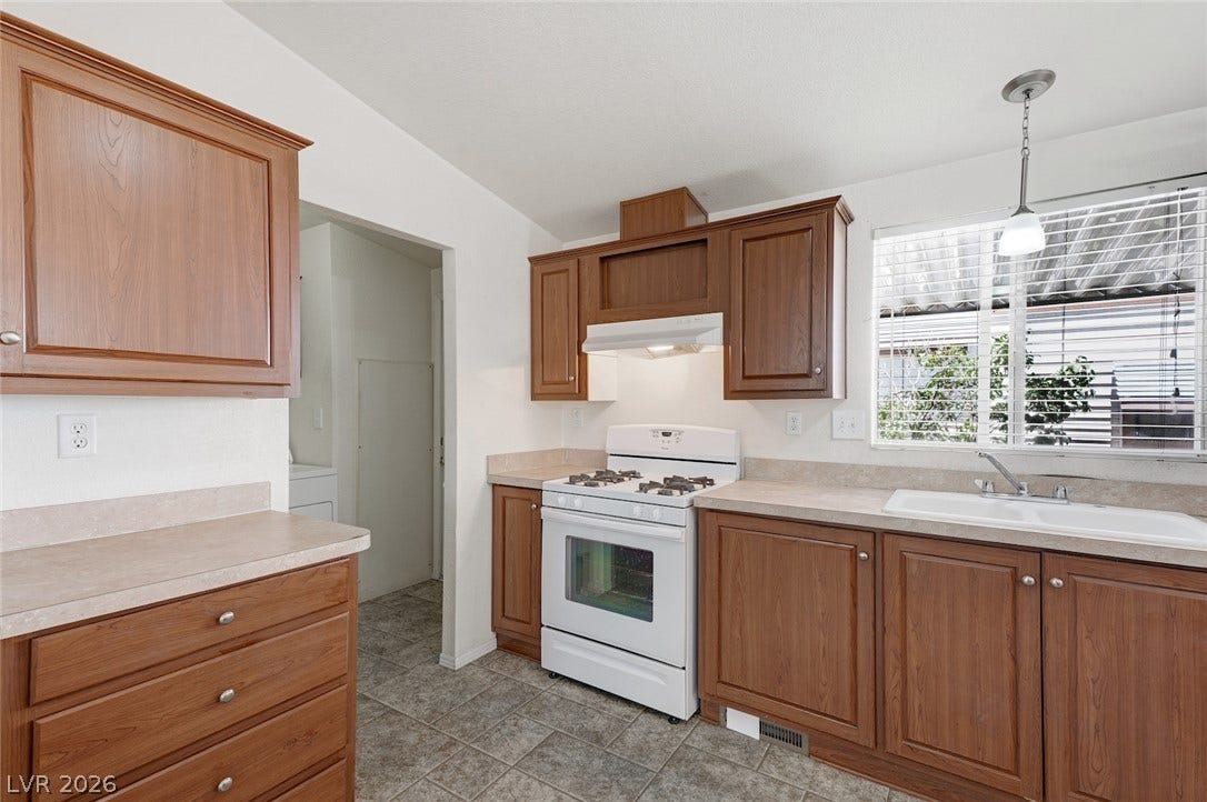 4589 Royal Ridge Boulevard, Las Vegas, NV 89103 Functional kitchen with ample cabinet space and modern appliances for daily culinary tasks.