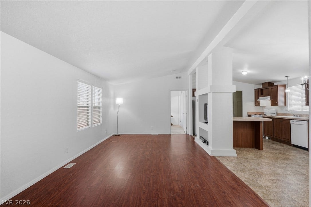 4589 Royal Ridge Boulevard, Las Vegas, NV 89103 Rich hardwood-style flooring extends from the living space into the open-concept kitchen.