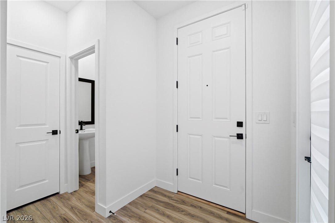 A well-appointed entryway features durable wood flooring and a clean, modern aesthetic.