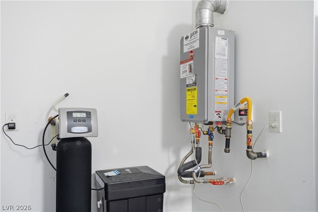 Essential utilities showcase a modern tankless water heater and water softener system.