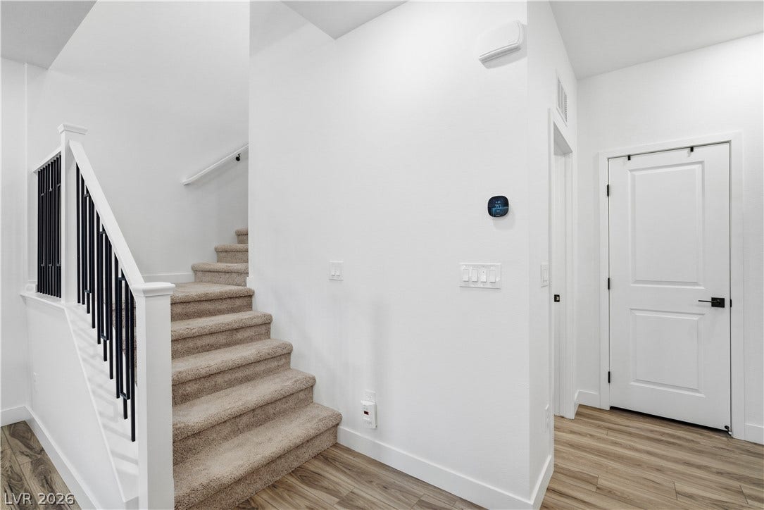 A gracefully designed staircase with modern railings leads to the upper level.