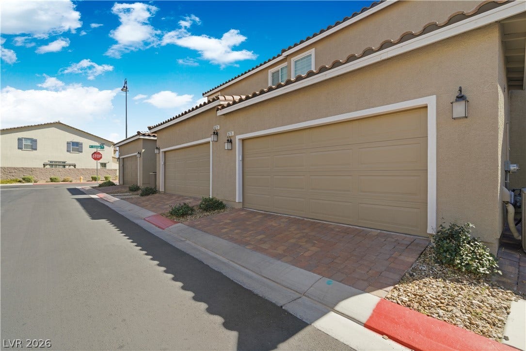 Attached garages with paver driveways offer convenient parking and access.
