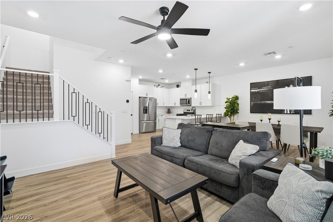 An open-concept living space integrates a modern kitchen and dining area, perfect for entertaining.