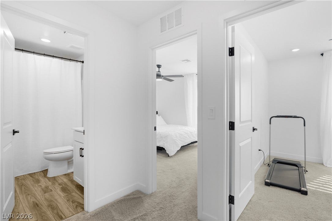 A well-lit interior hallway provides access to a bathroom, a bedroom, and a versatile bonus room.