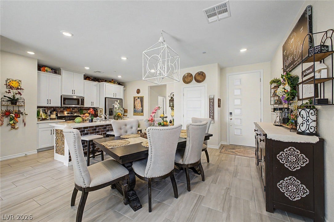 290 Fossil Falls Street, Henderson, NV 89015 An open-concept design seamlessly blends a functional kitchen with a refined dining area.