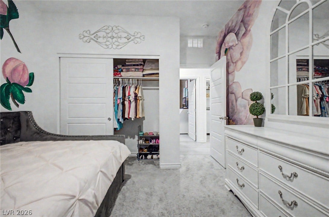 290 Fossil Falls Street, Henderson, NV 89015 A well-lit bedroom featuring a functional closet and a grand dresser with a stylish mirror.