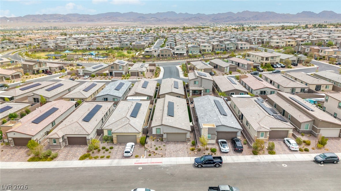 290 Fossil Falls Street, Henderson, NV 89015 An aerial perspective reveals a well-planned community with numerous homes and distant mountain vistas.
