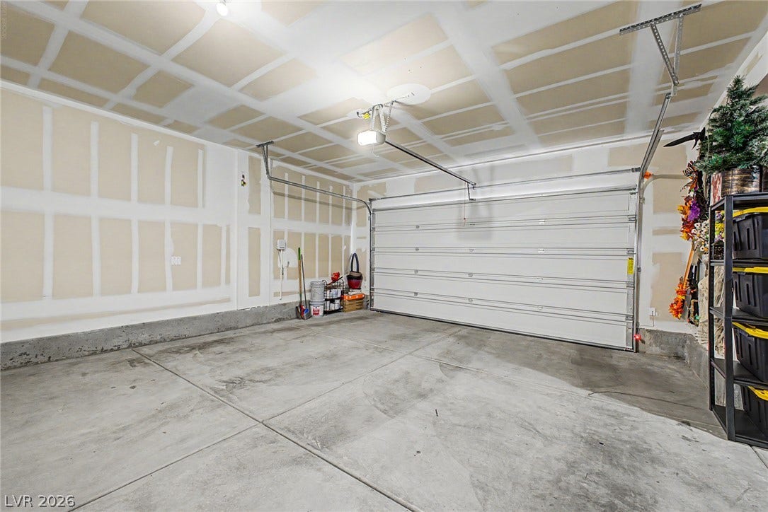 290 Fossil Falls Street, Henderson, NV 89015 A spacious and ready-to-customize garage features durable concrete flooring and a fully functional door.