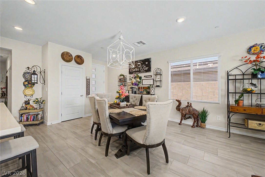 290 Fossil Falls Street, Henderson, NV 89015 Recessed lighting and a decorative chandelier illuminate this well-appointed dining area.