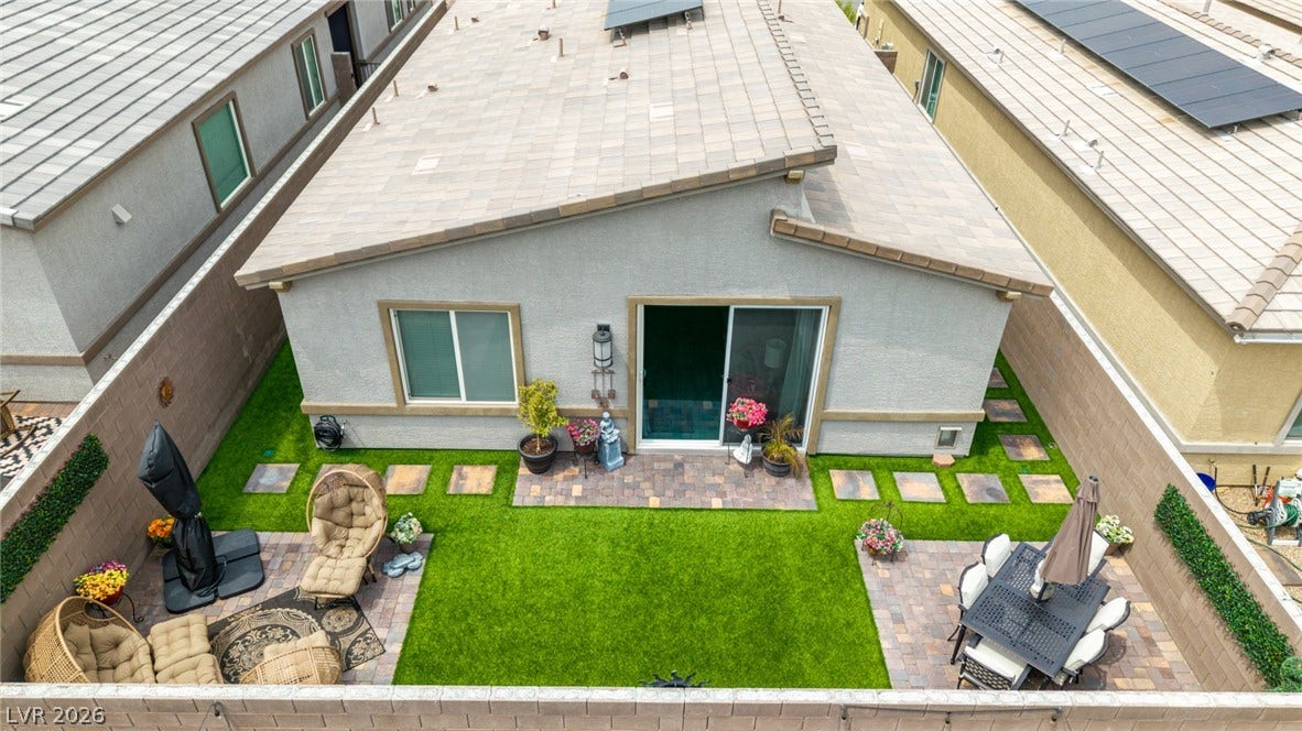 290 Fossil Falls Street, Henderson, NV 89015 A neatly manicured backyard offers multiple paved seating areas and lush artificial turf.