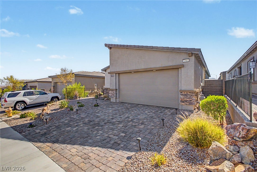 290 Fossil Falls Street, Henderson, NV 89015 A well-maintained front exterior with a paver driveway, attractive landscaping, and an attached garage.