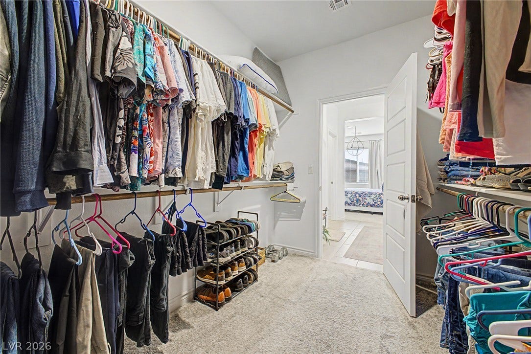 290 Fossil Falls Street, Henderson, NV 89015 A well-organized walk-in closet featuring extensive hanging space and convenient shelving leading to a bright primary suite.