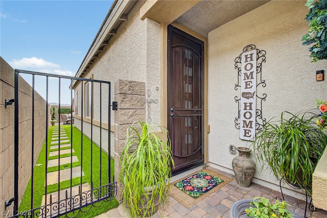 290 Fossil Falls Street, Henderson, NV 89015 A welcoming front entry features an ornate security door and a stepping stone path leading to a private outdoor space.