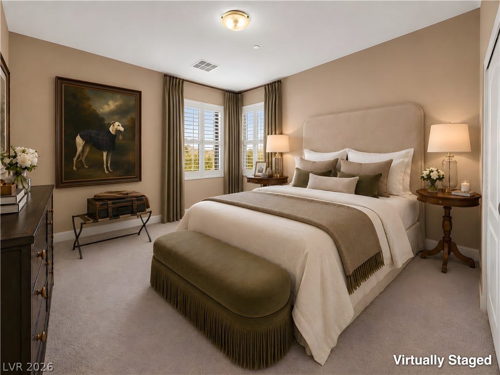 30 Benevolo Drive, Henderson, NV 89011 A tranquil primary bedroom with plush carpeting and natural light filtering through the window shutters.
