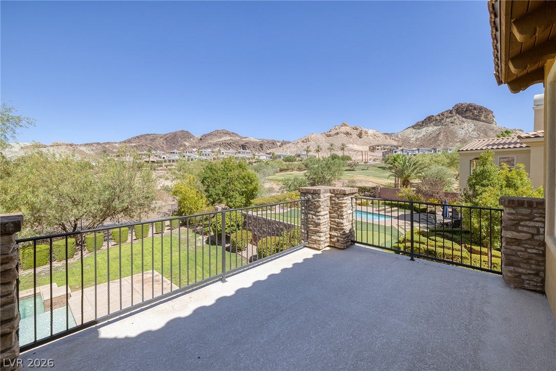 30 Benevolo Drive, Henderson, NV 89011 An elevated terrace offers panoramic views of distant mountains, green fairways, and a private pool.