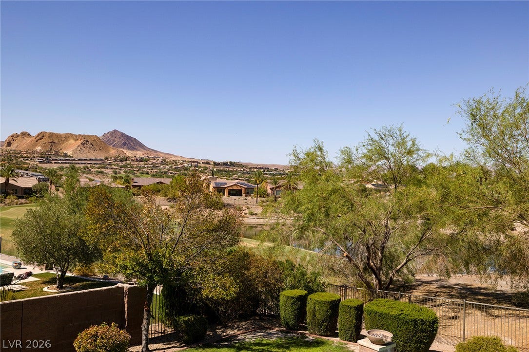 30 Benevolo Drive, Henderson, NV 89011 A tranquil outdoor living space offers captivating golf course, water, and mountain vistas.