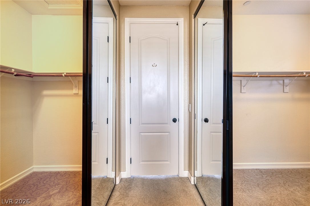 30 Benevolo Drive, Henderson, NV 89011 Functional mirrored closet doors frame a spacious, well-appointed walk-in closet with ample hanging space.