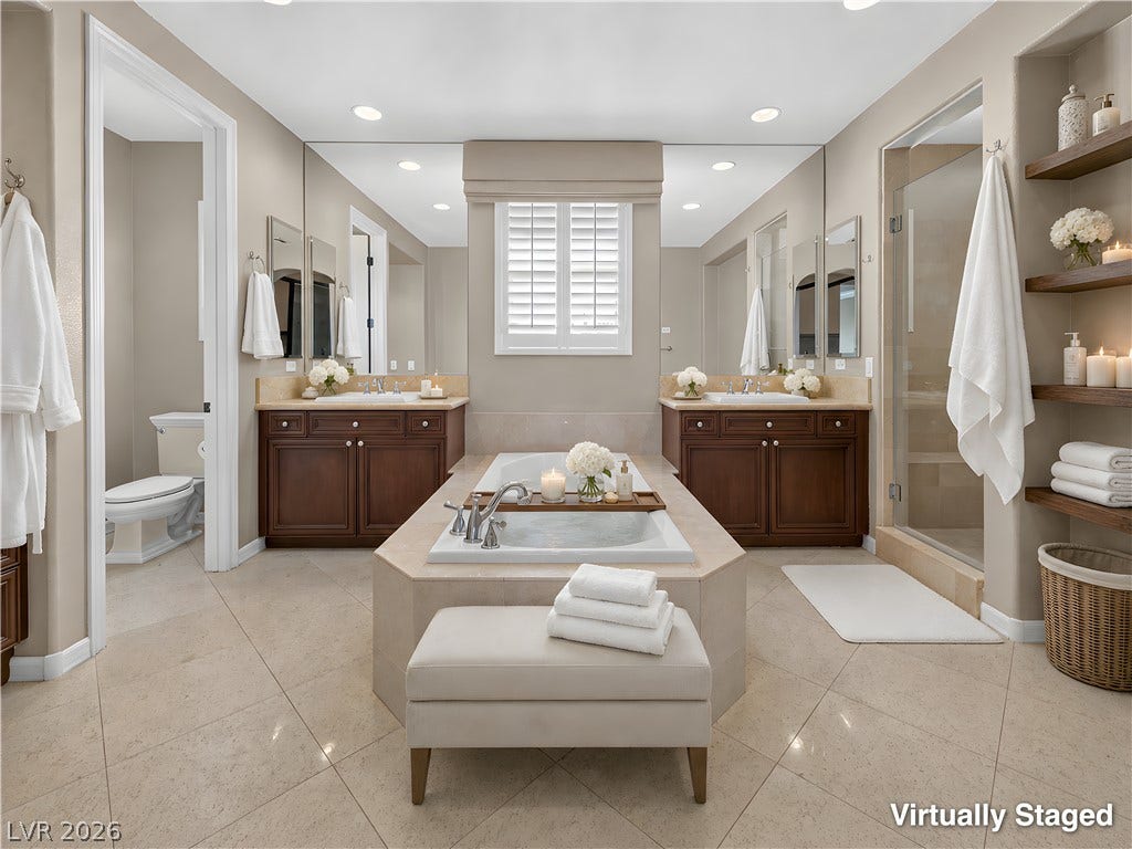 30 Benevolo Drive, Henderson, NV 89011 Indulge in a primary bathroom featuring a spacious soaking tub, dual vanities, and a walk-in shower.