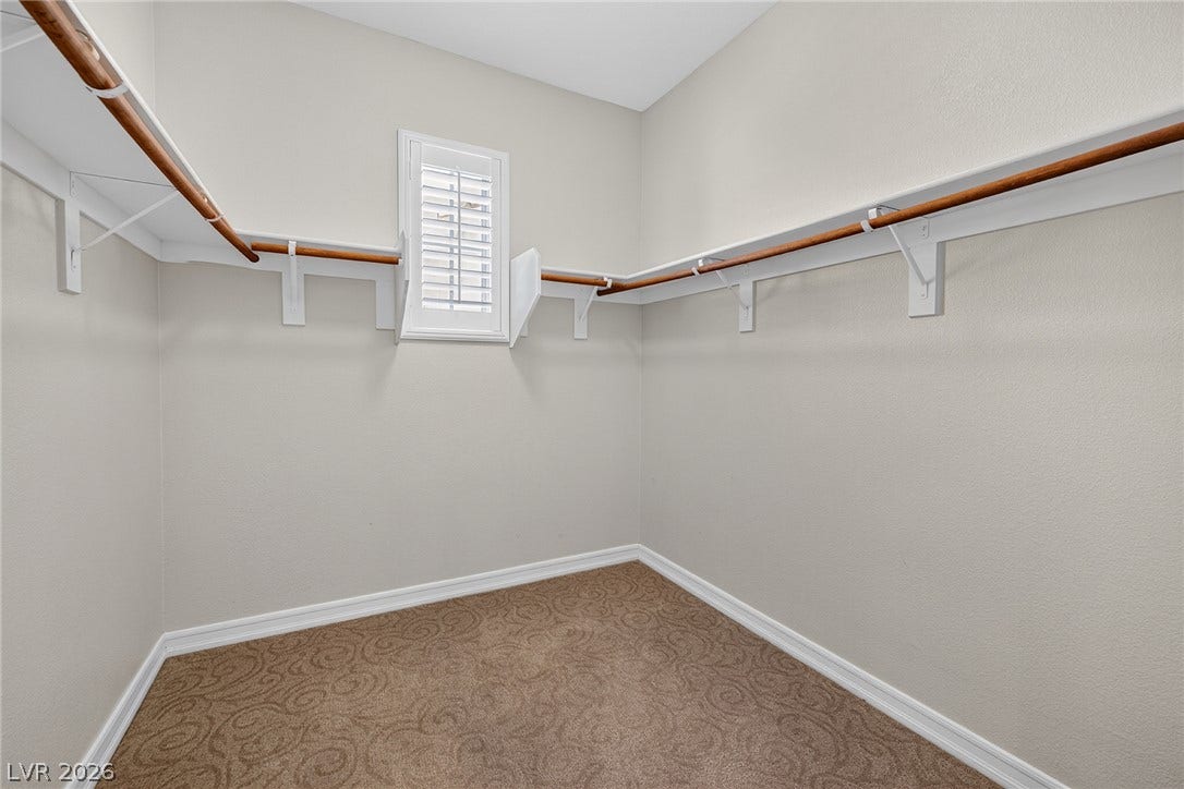 30 Benevolo Drive, Henderson, NV 89011 Ample hanging space and shelving define this well-appointed closet, offering practical storage solutions.