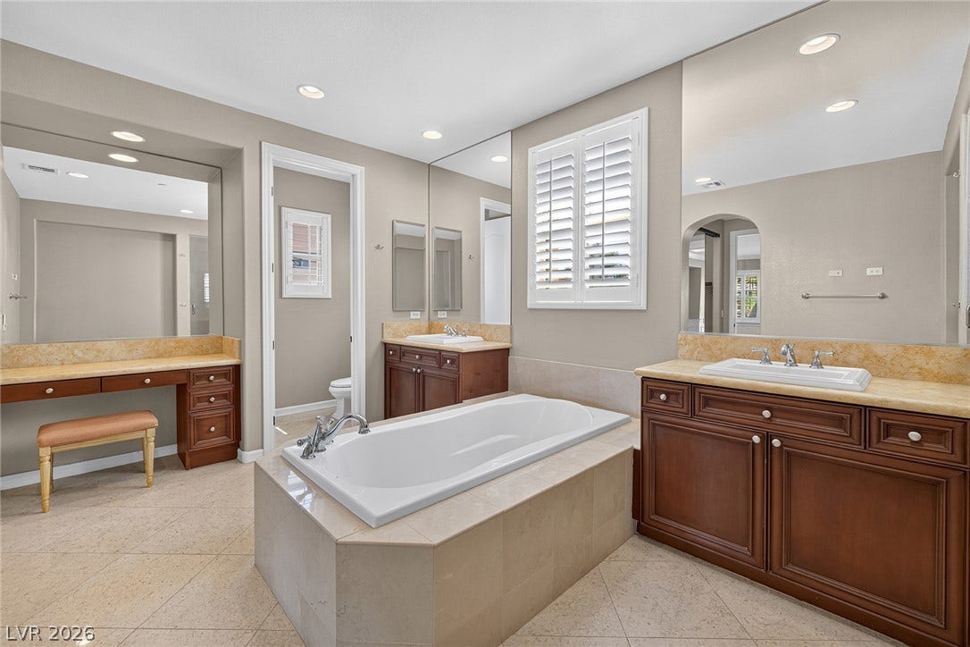 30 Benevolo Drive, Henderson, NV 89011 Luxurious primary bath features a spacious soaking tub, dual vanities, and an elegant make-up area.