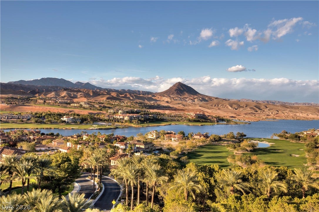 30 Benevolo Drive, Henderson, NV 89011 A winding road and verdant landscaping complement this master-planned community's lake, golf course, and mountainous surroundings.
