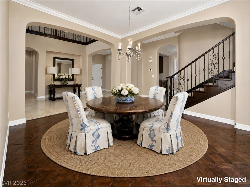 30 Benevolo Drive, Henderson, NV 89011 Ornate wrought iron balusters line the staircase, complementing the rich hexagonal wood flooring and crown molding in this grand foyer.