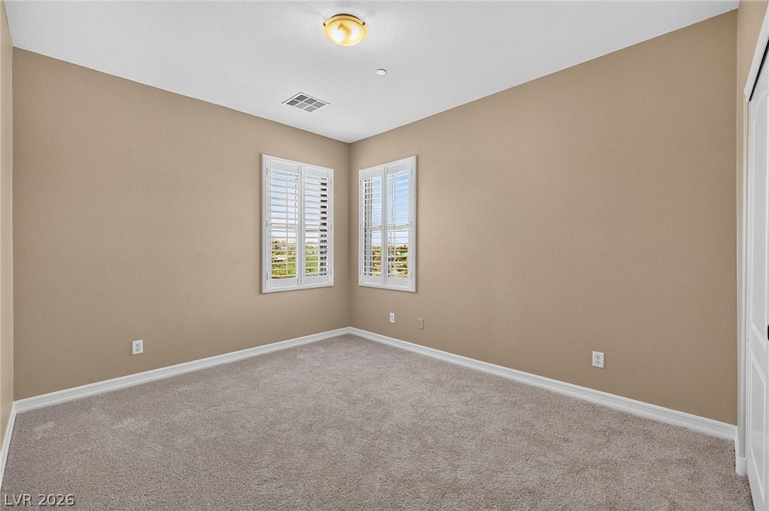 30 Benevolo Drive, Henderson, NV 89011 Two well-lit windows offer outside views in this carpeted, neutral-toned room.