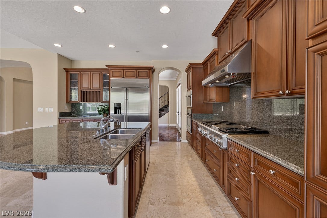 30 Benevolo Drive, Henderson, NV 89011 Gleaming granite countertops and rich wood cabinetry define this gourmet kitchen.