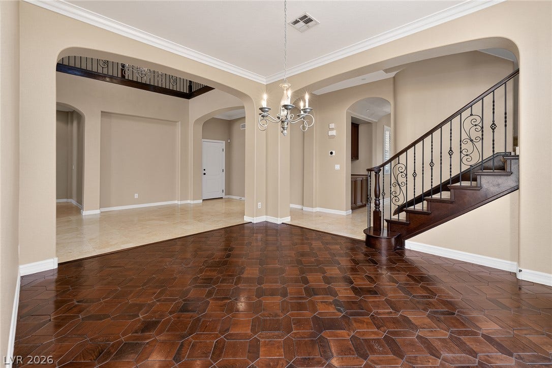 30 Benevolo Drive, Henderson, NV 89011 Ornate wrought iron banister and rich wood flooring lead to an inviting upper level.