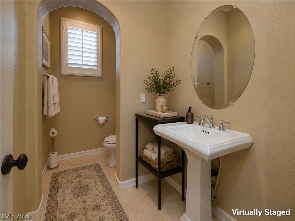 30 Benevolo Drive, Henderson, NV 89011 An inviting bathroom offers a pedestal sink and window with plantation shutters.