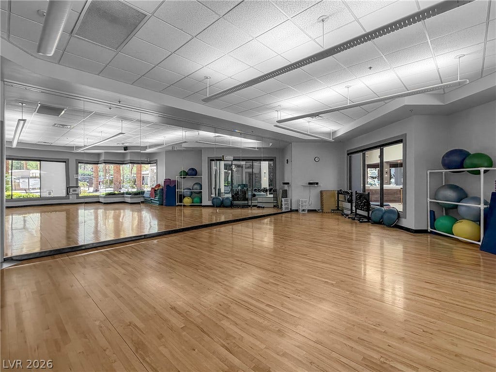 771 White Dogwood Court, Las Vegas, NV 89148 Hardwood flooring extends throughout this spacious gym, offering generous mirrored walls.