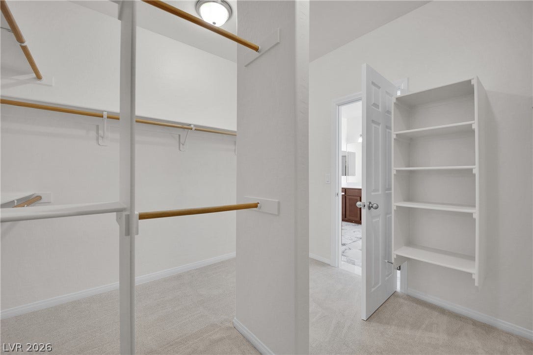 771 White Dogwood Court, Las Vegas, NV 89148 Ample hanging space and shelving create a well-organized closet system.