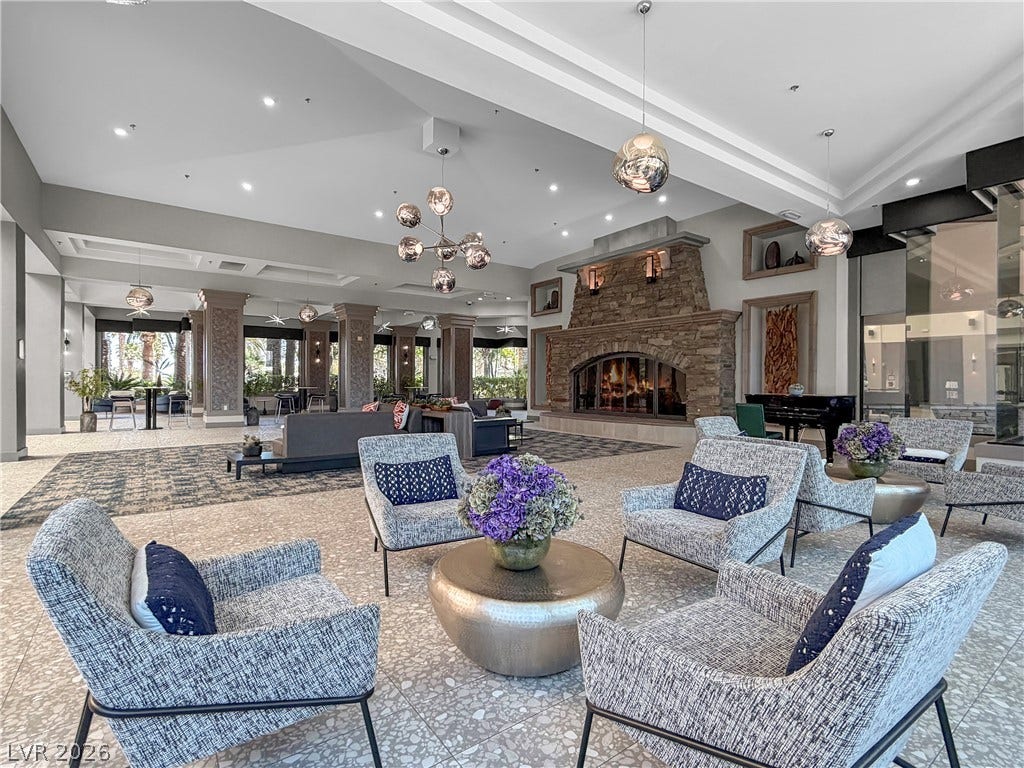 771 White Dogwood Court, Las Vegas, NV 89148 A grand communal lounge offers ample seating and a stately stone fireplace, ideal for relaxed gatherings.