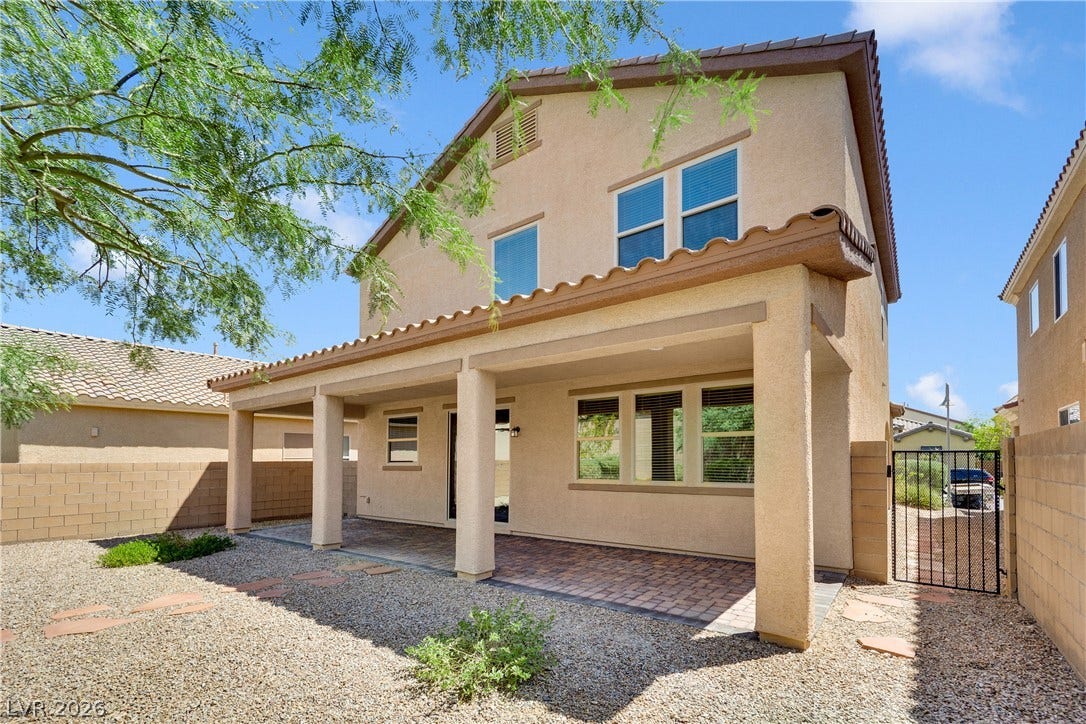 771 White Dogwood Court, Las Vegas, NV 89148 A well-maintained paved patio area with a gravel yard and privacy fencing offers an inviting outdoor space.