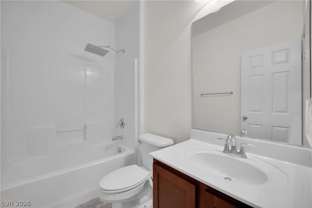 771 White Dogwood Court, Las Vegas, NV 89148 Crisp tiled tub surrounds and a modern vanity highlight this functional bathroom space.