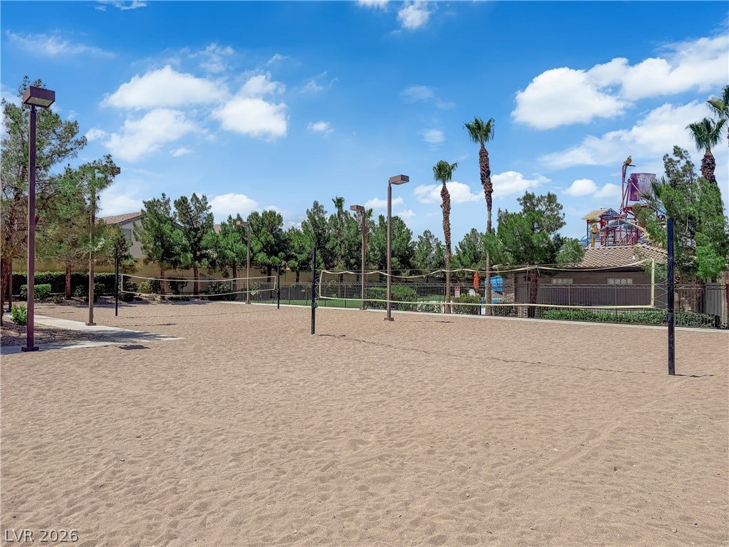 771 White Dogwood Court, Las Vegas, NV 89148 A community sand volleyball court awaits, offering active outdoor recreation under a bright sky.