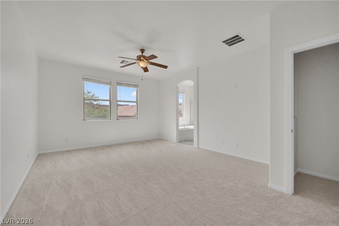 771 White Dogwood Court, Las Vegas, NV 89148 Soft carpeting pairs with neutral walls in this comfortable bedroom featuring views of the neighborhood.