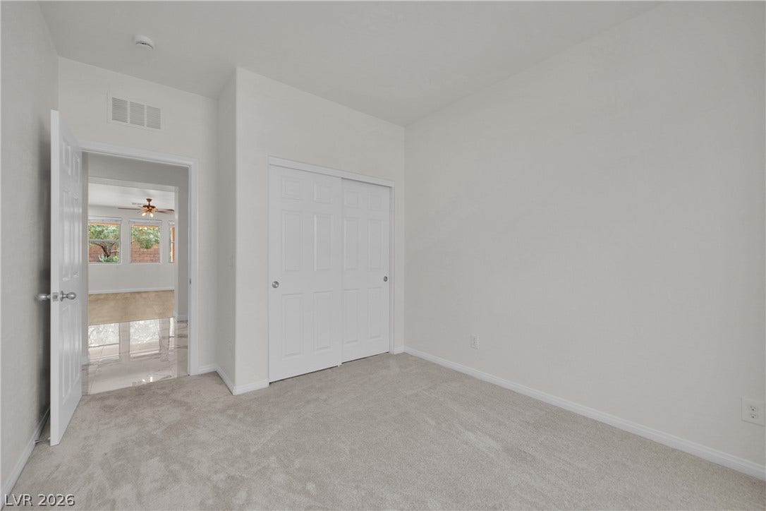 771 White Dogwood Court, Las Vegas, NV 89148 Soft carpeting pairs with neutral walls in this versatile bedroom complete with sliding closet doors.