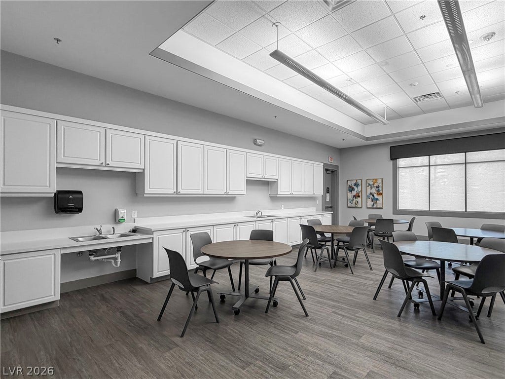 771 White Dogwood Court, Las Vegas, NV 89148 A well-appointed community kitchen area offers ample counter space, white cabinetry, and durable flooring for gatherings.