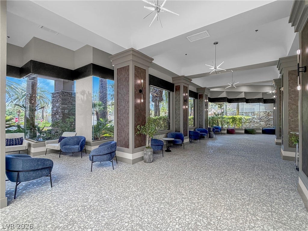 771 White Dogwood Court, Las Vegas, NV 89148 An inviting foyer with ample seating and large windows offers serene views of lush outdoor greenery.