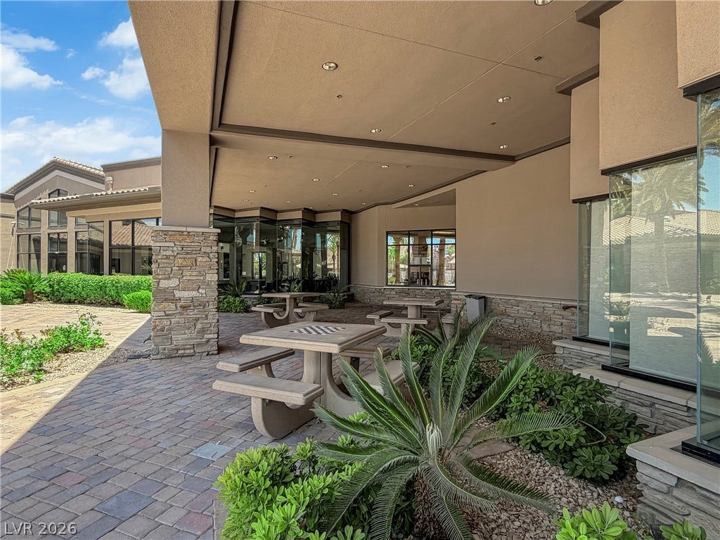 771 White Dogwood Court, Las Vegas, NV 89148 An inviting outdoor patio offers comfortable seating and lush landscaping, perfect for relaxation or casual gatherings.
