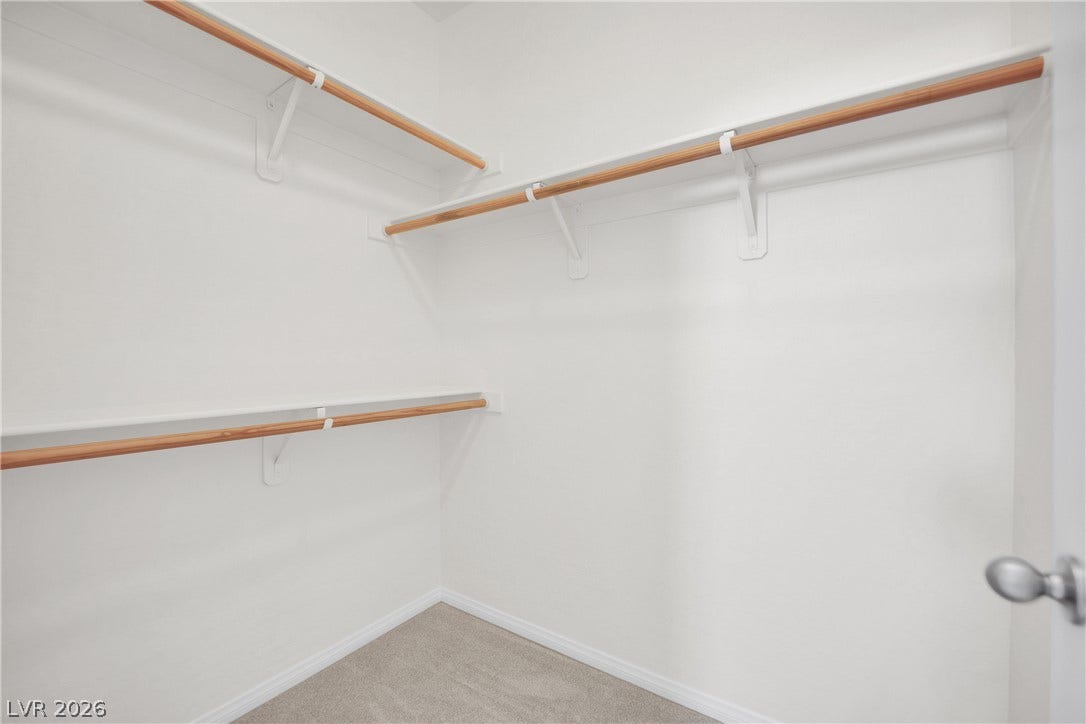 771 White Dogwood Court, Las Vegas, NV 89148 Ample hanging space and shelving create an organized walk-in closet for effortless storage.