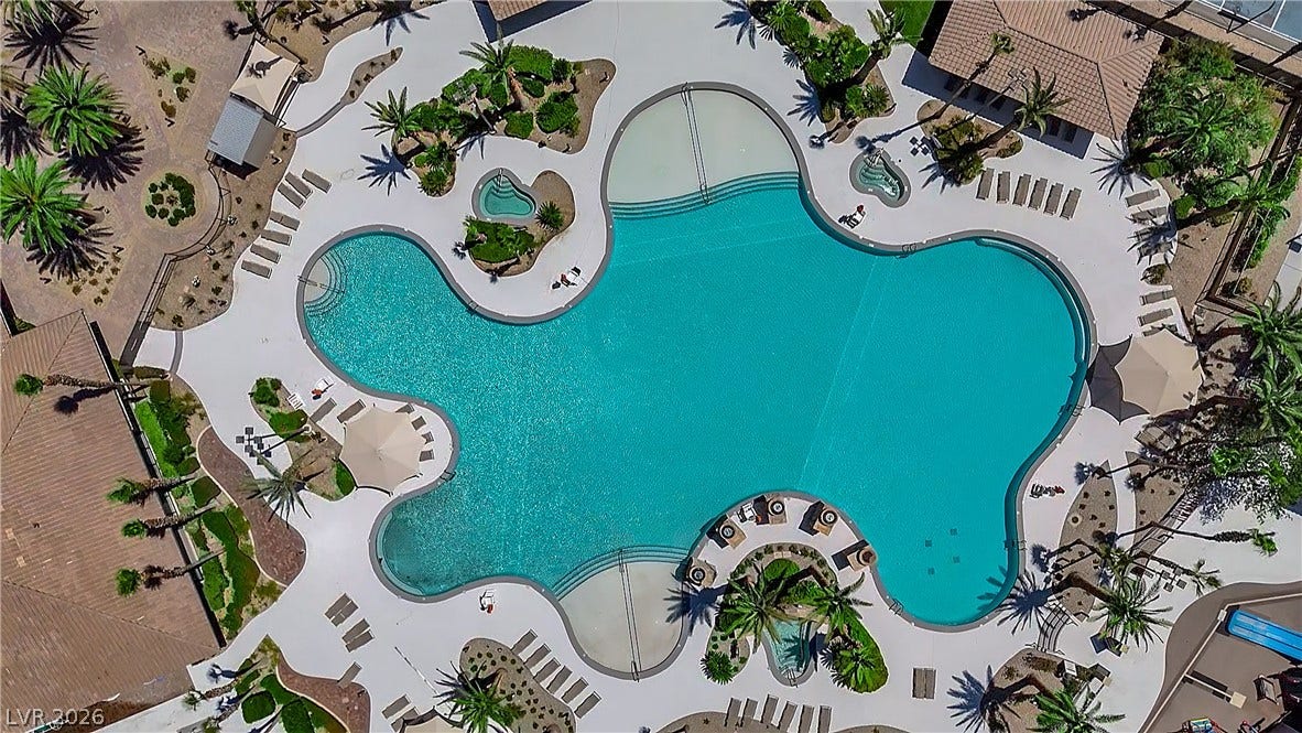 771 White Dogwood Court, Las Vegas, NV 89148 An aerial perspective reveals a resort-style community pool, offering ample lounging space and verdant landscaping.