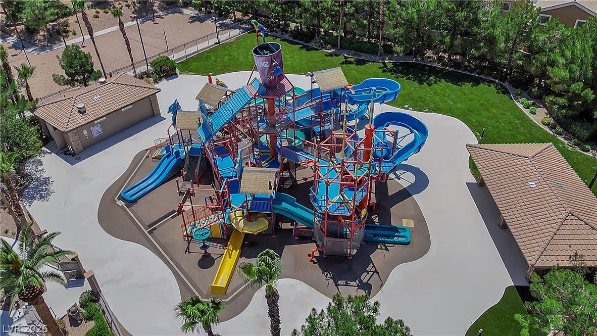 771 White Dogwood Court, Las Vegas, NV 89148 A vibrant water park amenity with an array of slides and play structures.