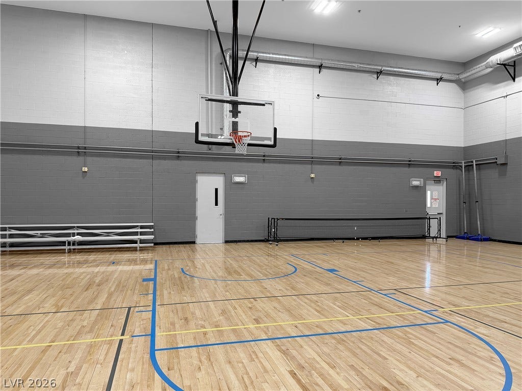771 White Dogwood Court, Las Vegas, NV 89148 An indoor sports court with hardwood flooring and a basketball hoop offers dynamic recreational opportunities.