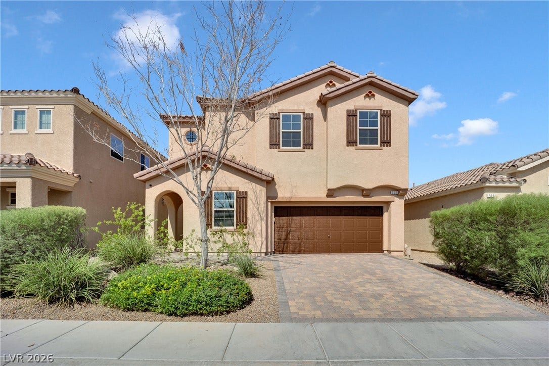 771 White Dogwood Court, Las Vegas, NV 89148 A traditional stucco exterior with a tiled roof offers inviting curb appeal.