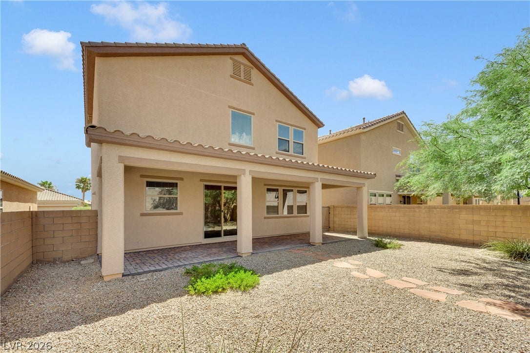 771 White Dogwood Court, Las Vegas, NV 89148 A spacious backyard with a covered patio offers ample outdoor living space.