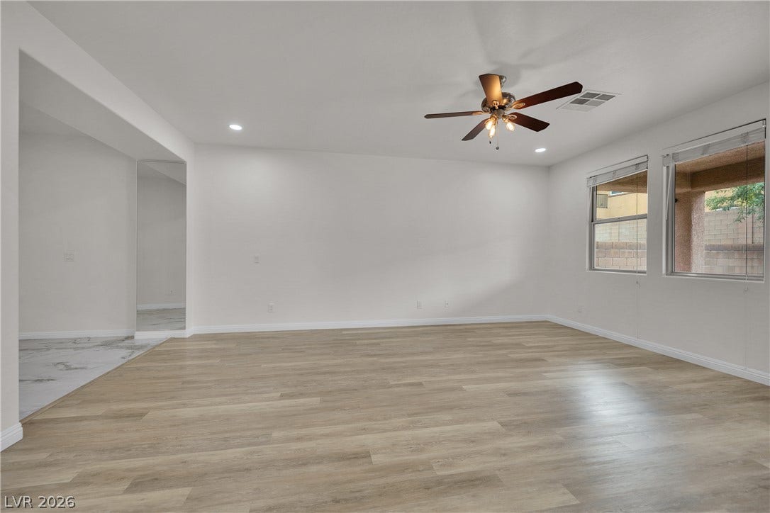 771 White Dogwood Court, Las Vegas, NV 89148 Smooth wood-look flooring and tall windows create an open, airy atmosphere in this versatile space.