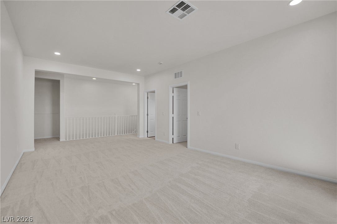 771 White Dogwood Court, Las Vegas, NV 89148 A spacious and inviting upstairs landing with neutral carpeting and abundant recessed lighting.