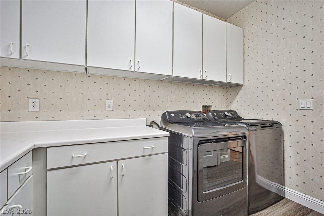 1828 Dolce Drive, Las Vegas, NV 89134 Functional laundry room featuring abundant cabinet storage and convenient countertop space for daily tasks.